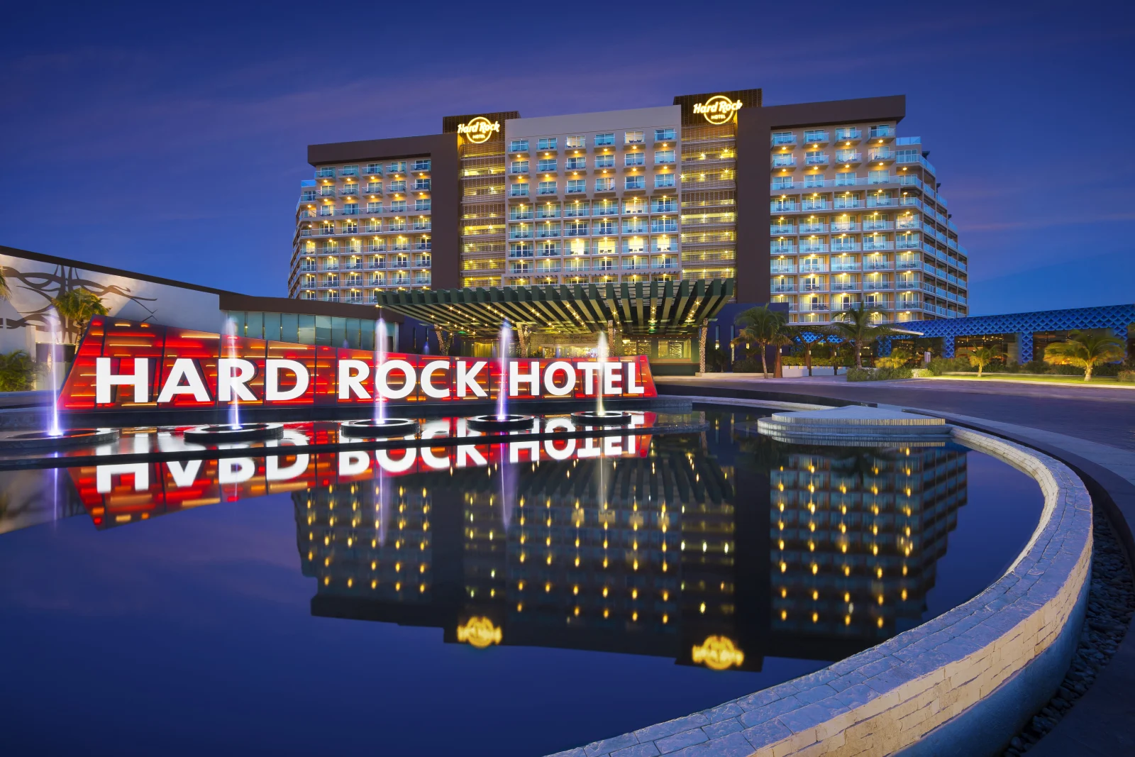 Hard Rock Hotel Cancún illuminated exterior and signature sign at dusk
