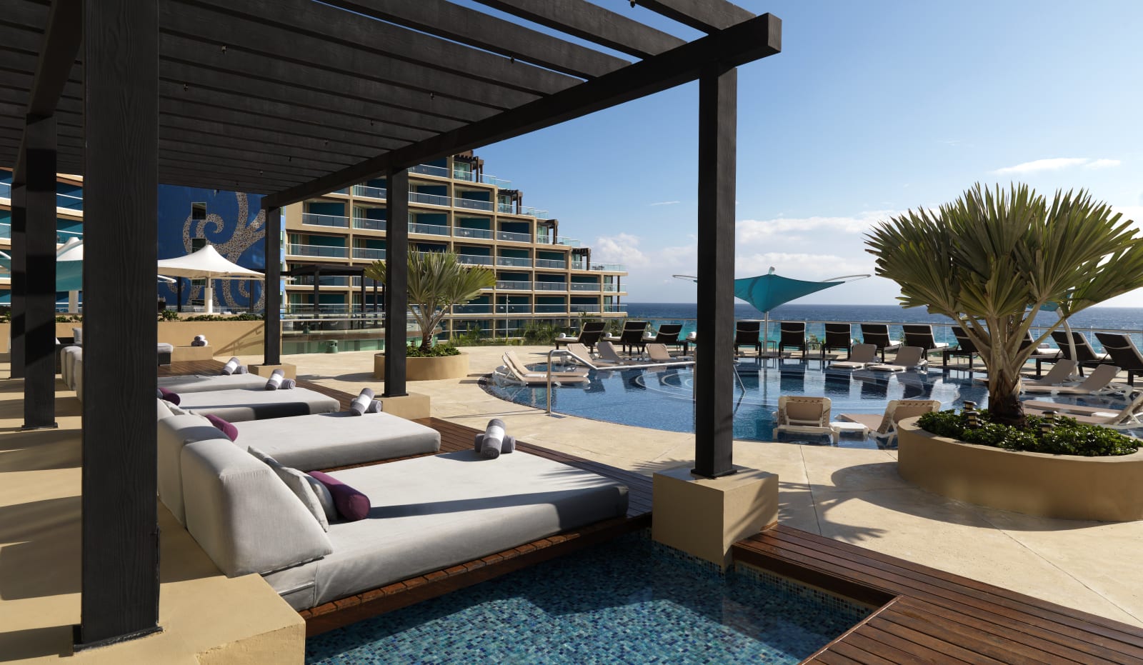 Poolside daybeds and oceanview pool deck at Hard Rock Hotel Cancún
