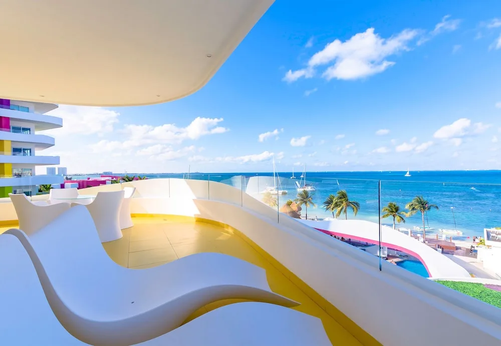 Suite terrace with sculpted loungers overlooking Bahía de Mujeres at Temptation Cancun Resort