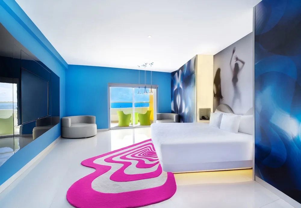 Ocean-view guest room at Temptation Cancun Resort in Karim Rashid's blue and pink design